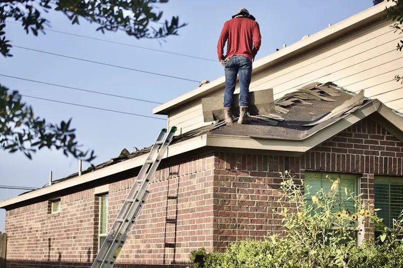 Professional roofer working on a residential roof in Matthews Beach